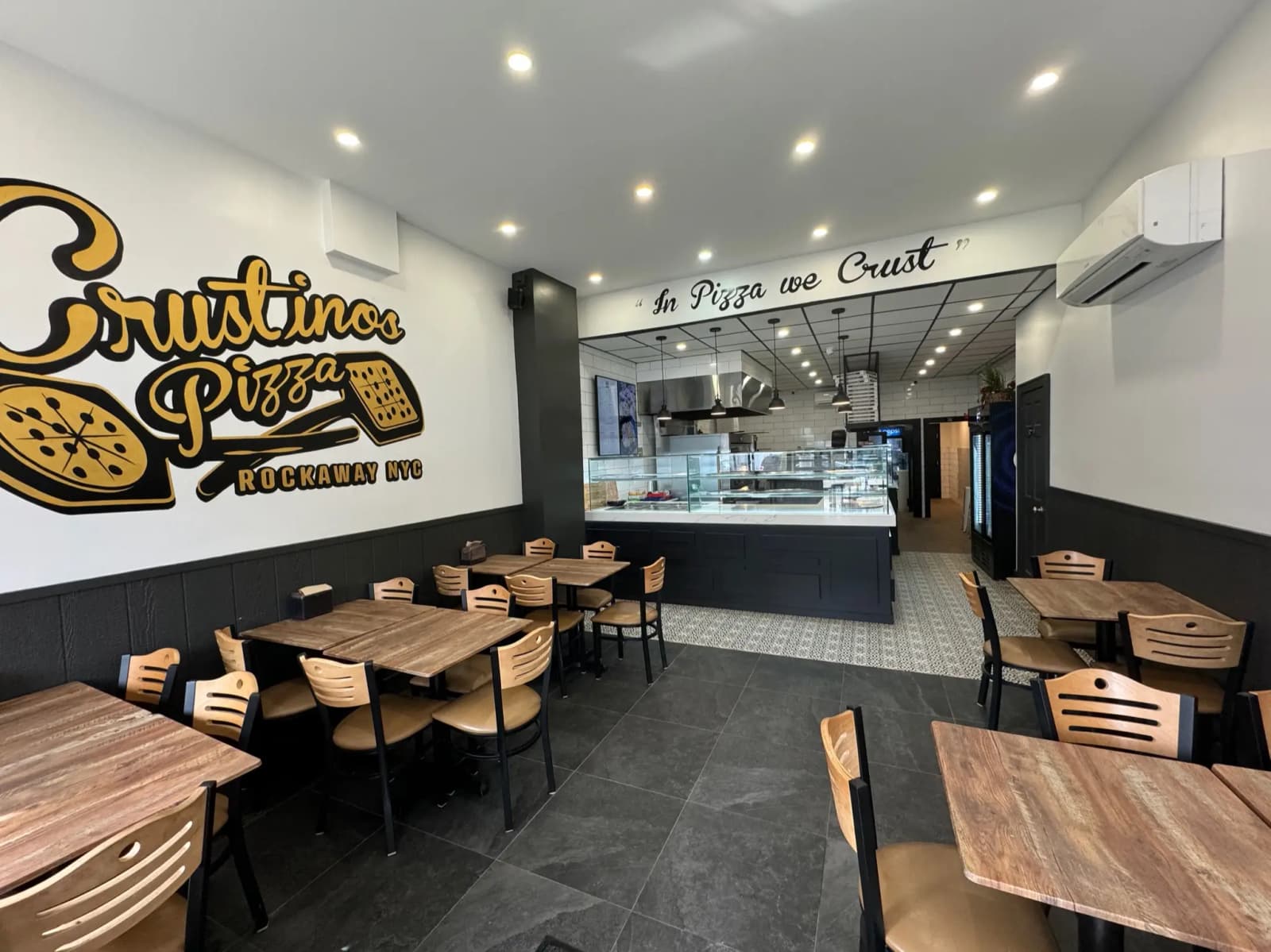 Interior view of Crustinos Pizza, highlighting their welcoming space and authentic pizzeria atmosphere.
