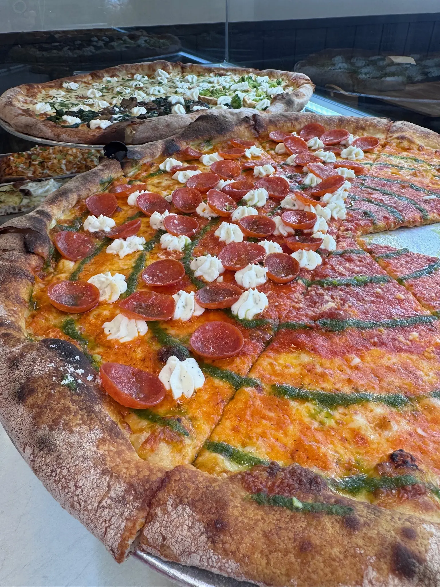 Freshly baked focaccia bread from Crustinos Pizza, topped with herbs and mozzarella.